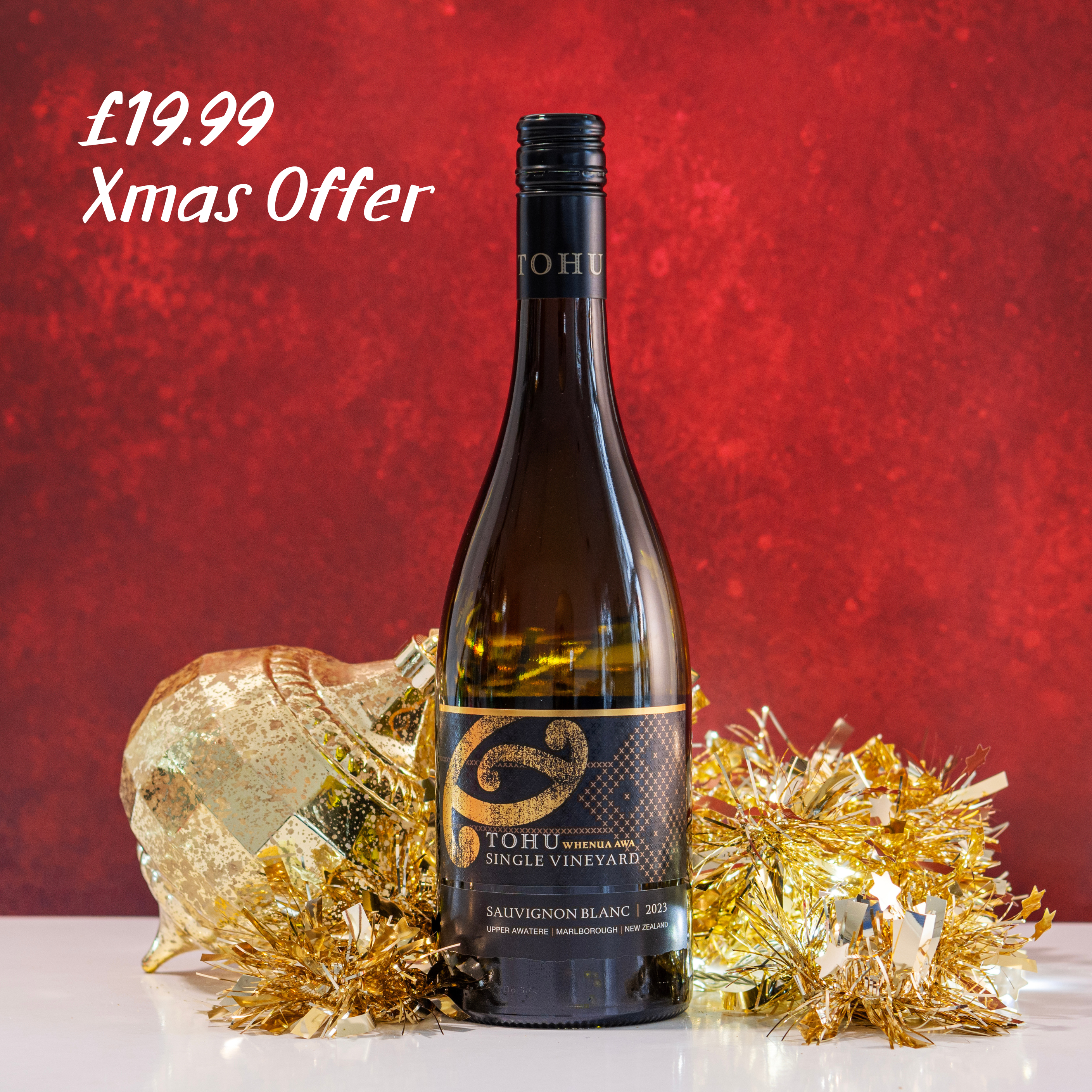 Bottle of Tohu Sauvignon Blanc with gold decorative elements on a red background, featuring a Christmas offer.