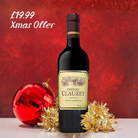 Bottle of Château Clauzet wine with Christmas decorations on a red background