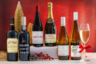 Assorted wine bottles on a red background with a glass of champagne.